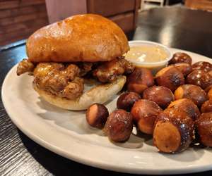 Zesty chicken sandwich with pretzel balls and mustard dipping sauce. 